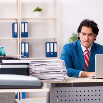 internet fax service best ringcentral online fax service man in blue suit in the office on desk folders and laptop on his desk and in the background